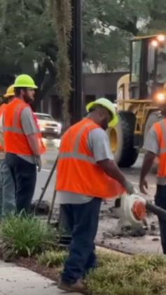 Crew members work beside a damaged Tallahassee manhole after the underground electrical fire