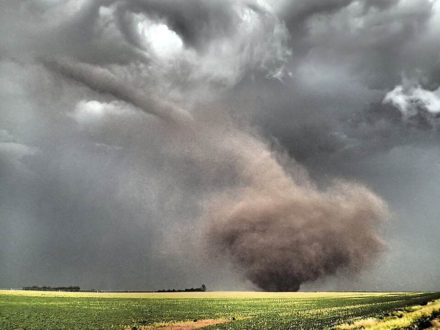 A tornado beneath severe storm clouds over Oklahoma farmland in a weather file photograph