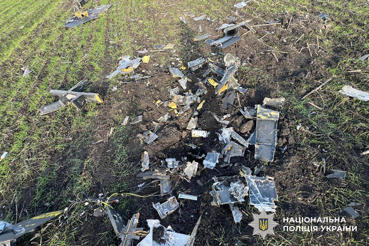 Fragments of a destroyed Russian attack drone scattered in a field in Ukraine