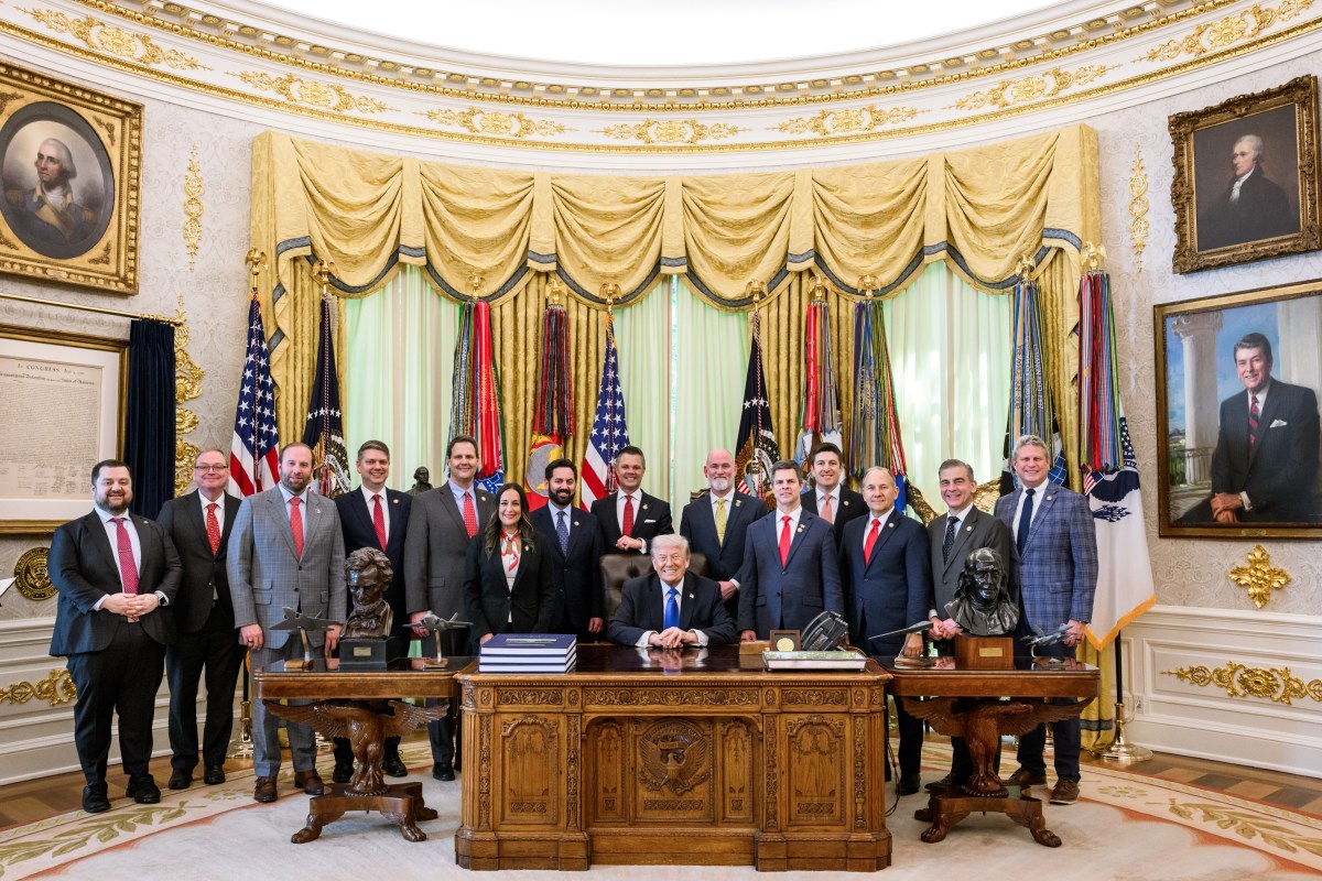 President Donald Trump with officials in the Oval Office after an executive-order signing in April 2026