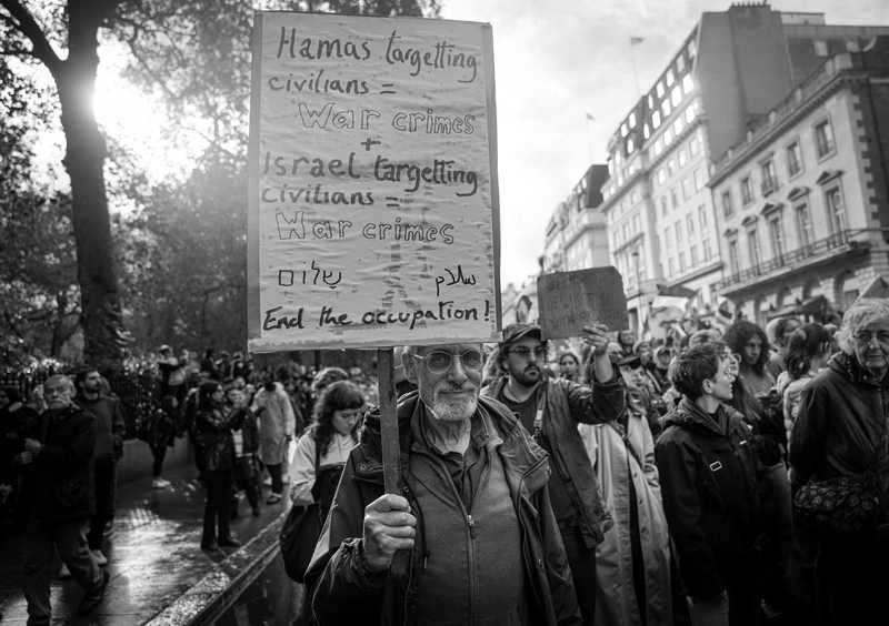 Large London Palestine protest in October 2023 carrying anti-war-crimes signs
