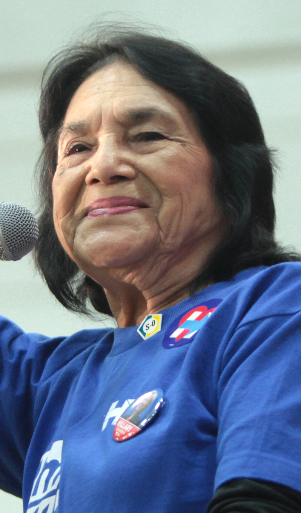 Dolores Huerta speaking into a microphone at an event in Phoenix, Arizona, in 2016