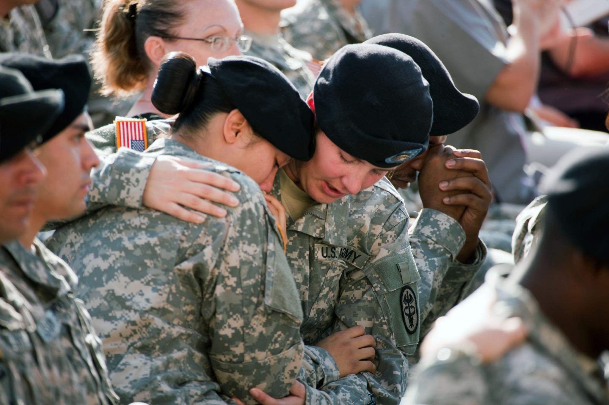 Soldiers comfort one another at the 2009 Fort Hood memorial service for the shooting victims