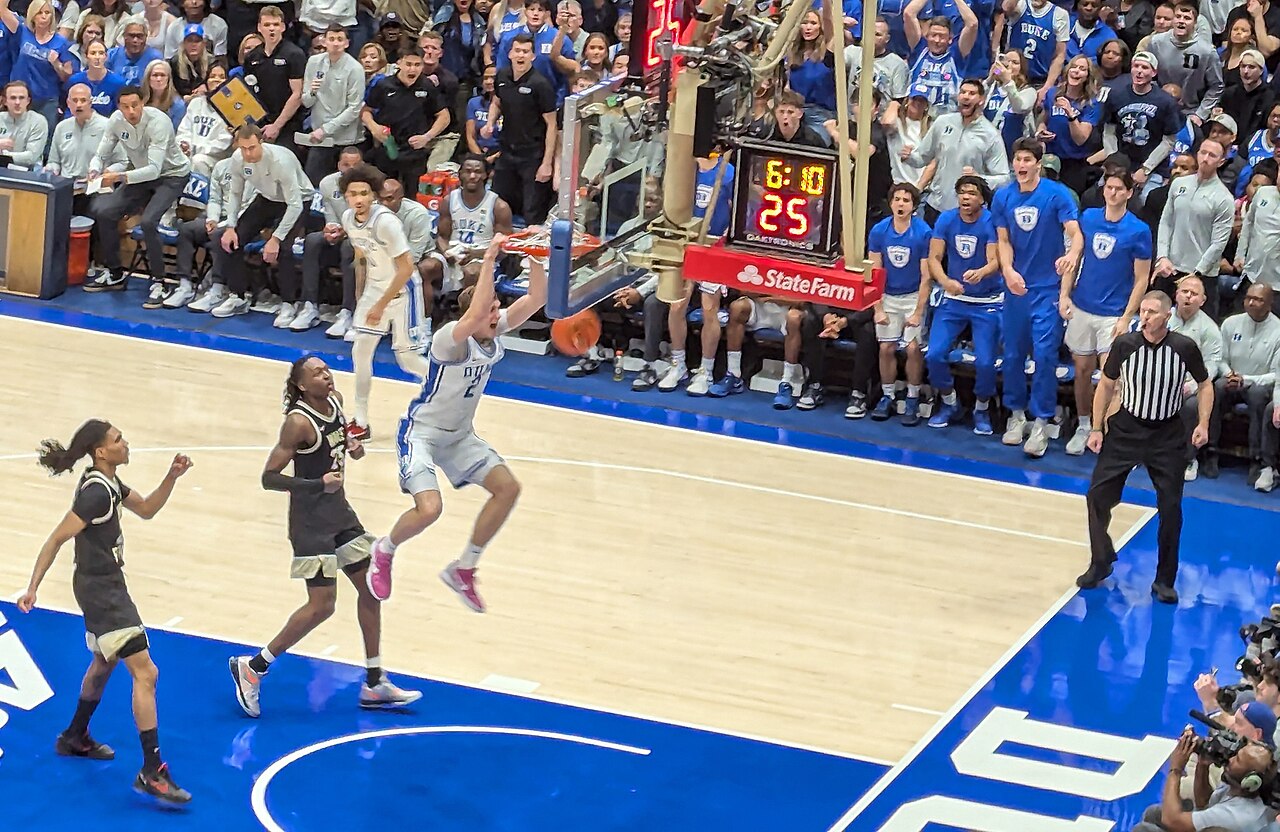 Cooper Flagg dunking for Duke against Wake Forest in March 2025 — the breakaway play in Indianapolis ended with Flagg on the floor holding his left shoulder