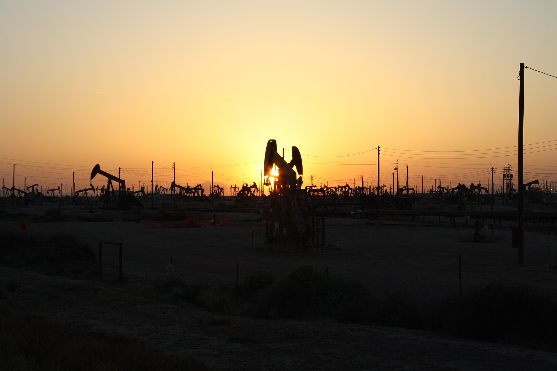 Pumpjacks working at sunset in the Lost Hills oil field, California — oil prices Brent WTI file photograph