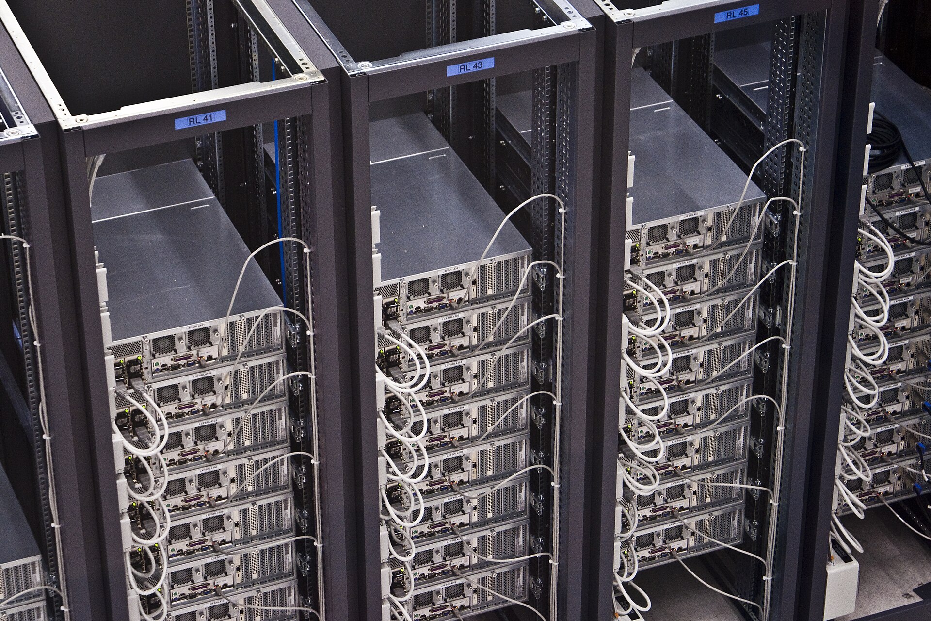 Rows of server racks in a data centre — business investment in information-processing equipment surged in the third quarter as companies built out AI computing capacity, a file photograph