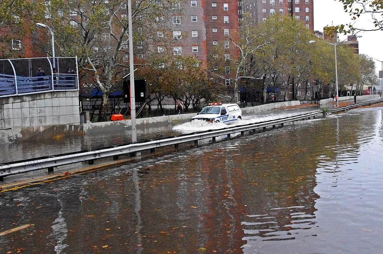 Floodwater covering FDR Drive in New York after Hurricane Sandy, illustrating how coastal storms can disrupt roads and mass gatherings