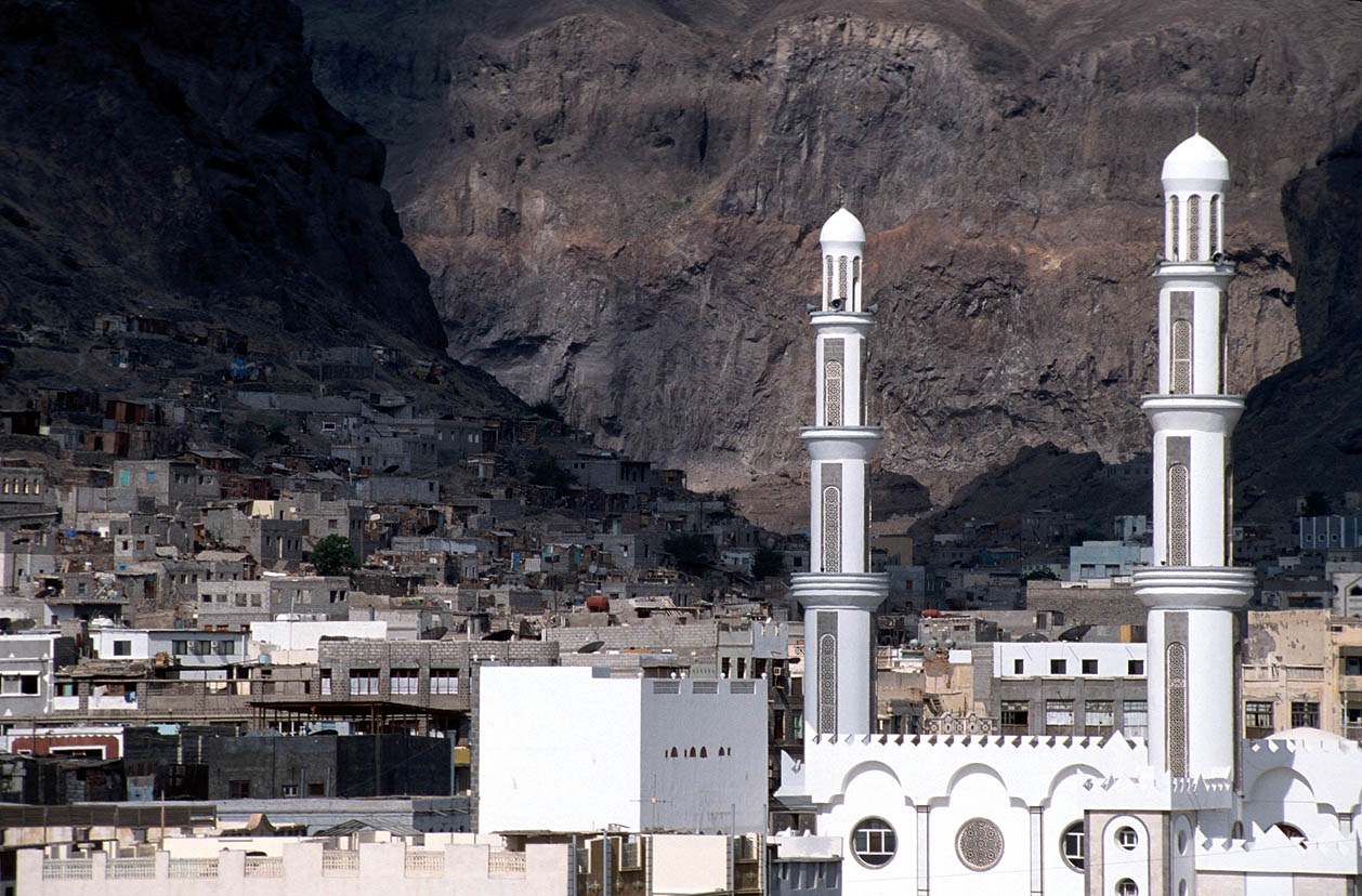 Aden's old town and mosque minarets beneath the Crater cliffs in Yemen — Houthi attack Aden presidential palace context photograph