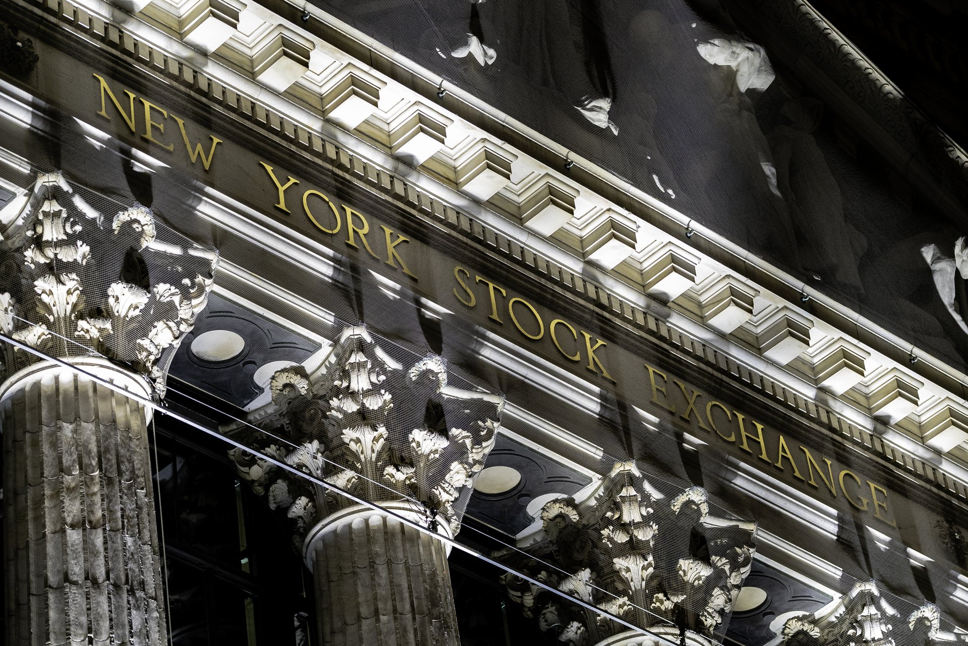 The New York Stock Exchange sign and pediment on Broad Street in New York — markets rose modestly after the Fed rate decision October 2026