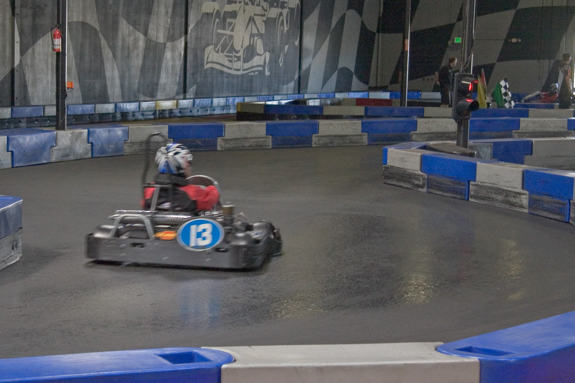 Junior kart racing action — young drivers competing wheel to wheel in a karting race