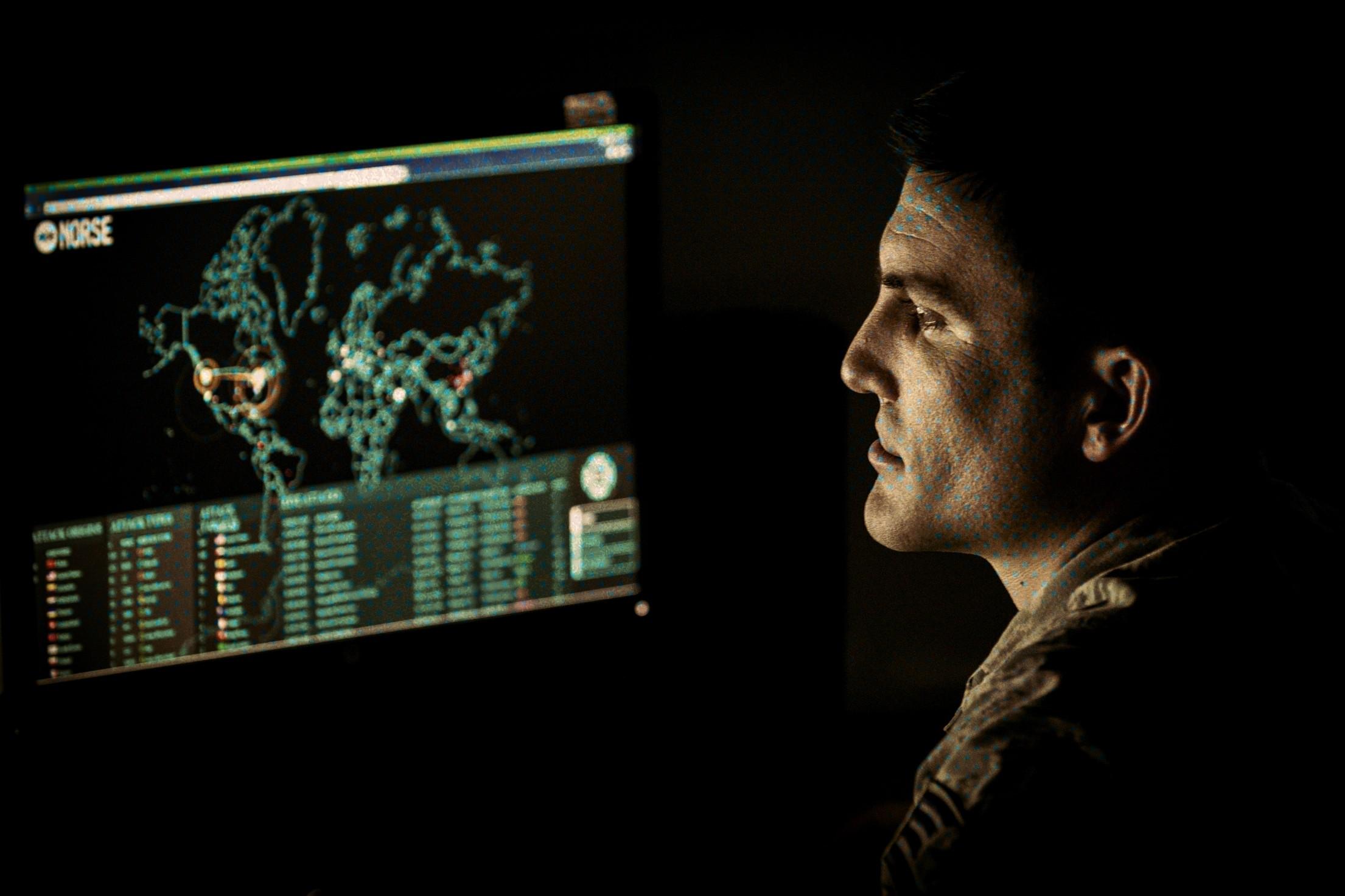 DMDC data breach — a U.S. service member monitoring a live cyber-attack map during cyber operations training, the defensive work the lawsuit says failed at the Pentagon personnel center
