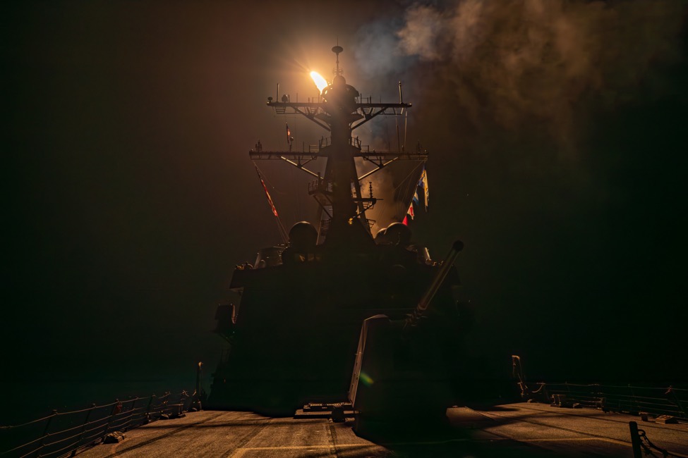 A US Navy destroyer launches a missile at night during strikes on Houthi targets in Yemen — missile exchanges over Yemen file photograph