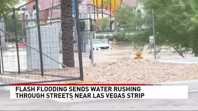 A car driving through floodwater on a Las Vegas street during the October 2026 flash flood