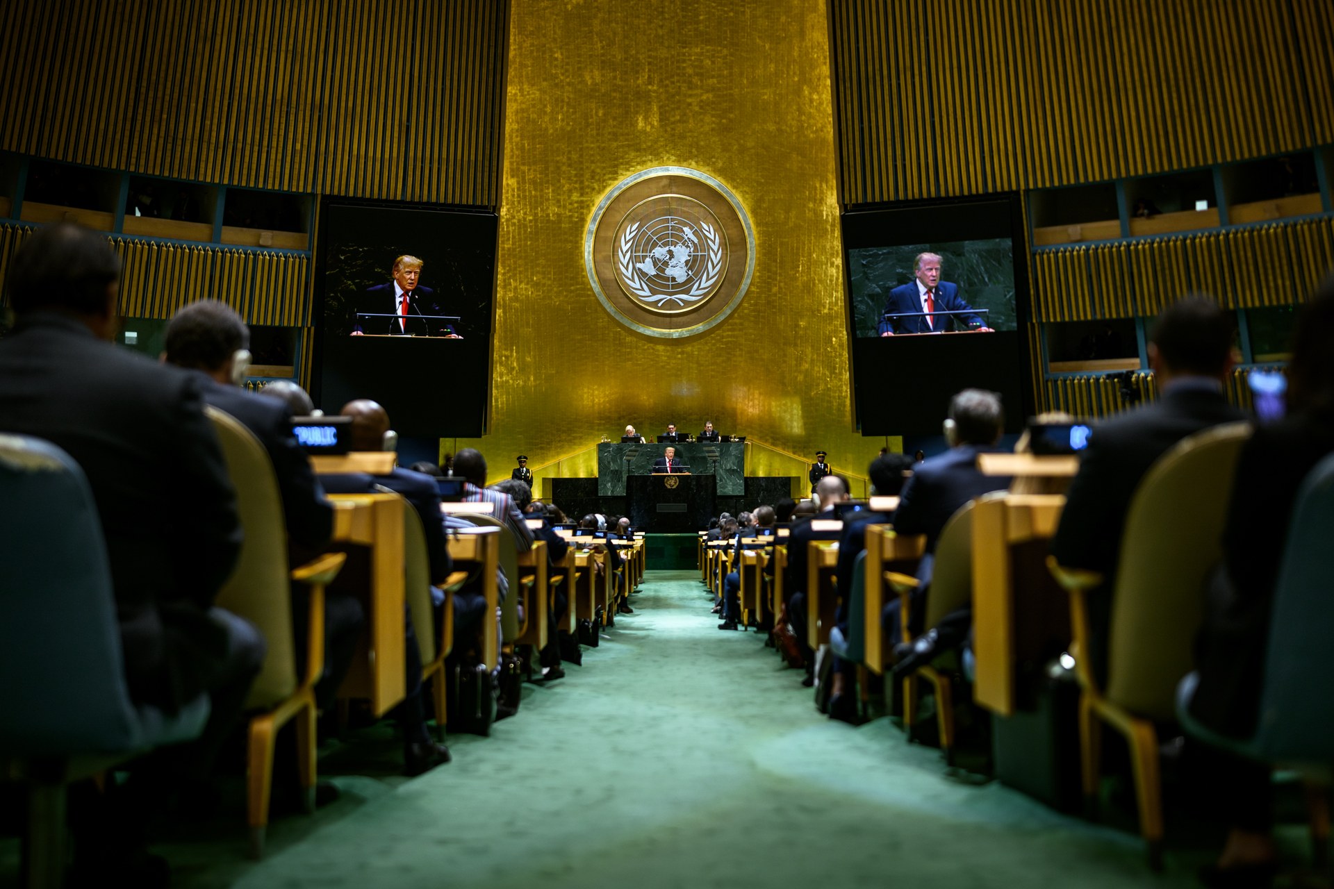 President Donald Trump addresses the 81st session of the UN General Assembly in September 2026, seen on the hall screens — the president who now says a deal with Iran is 100 percent close