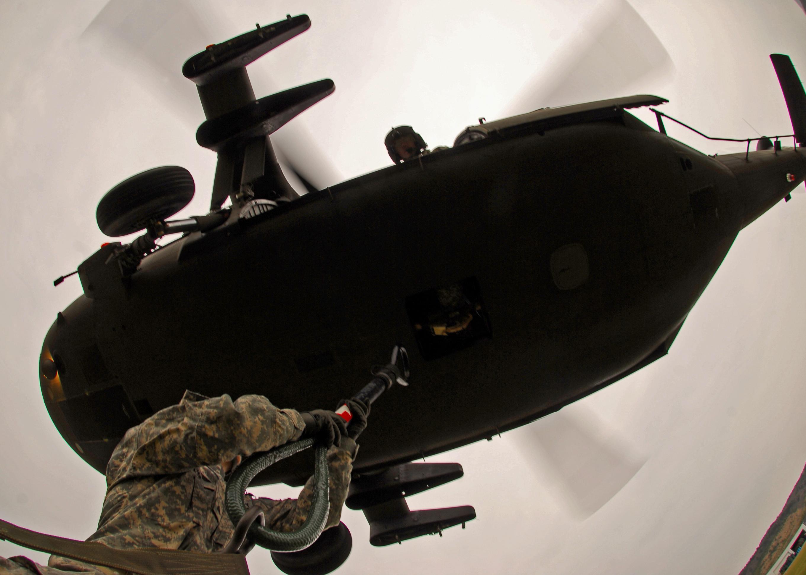A U.S. Army UH-60 helicopter crew moving bottled water during disaster relief operations in Japan — a file photograph