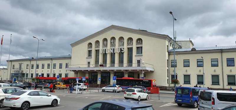 Vilnius Airport main entrance beneath storm clouds, illustrating the October 2026 drone alert and temporary closure