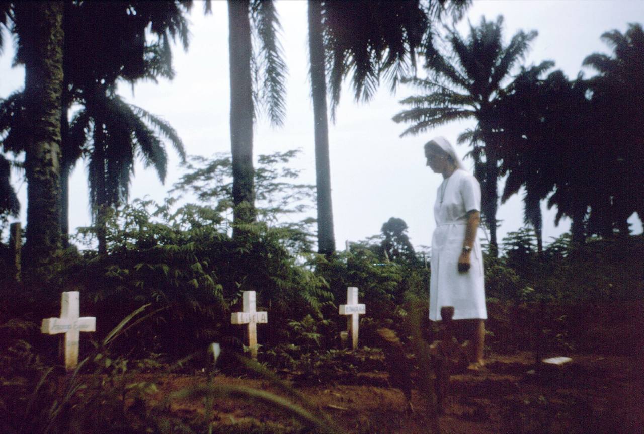 A nurse walks among the graves of victims of the 1976 Ebola outbreak in Zaire — the virus's first known appearance, in what is now DR Congo