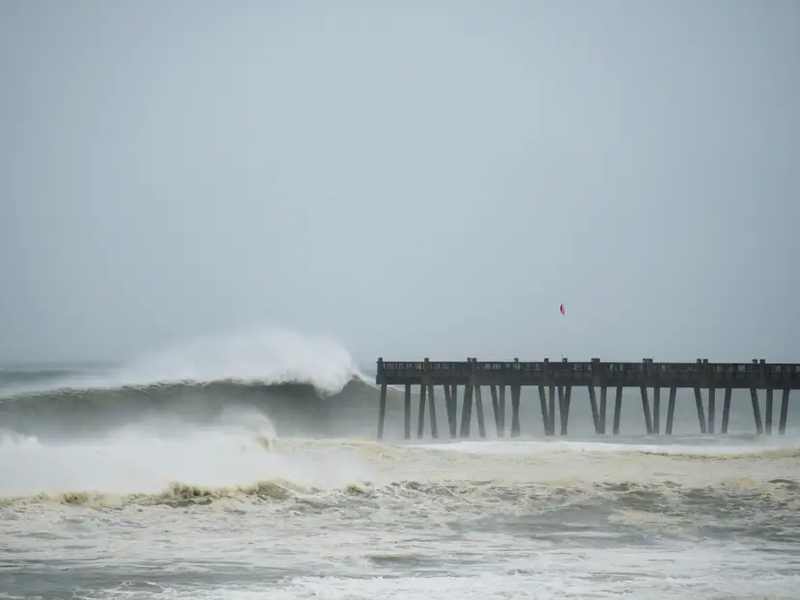 Large waves breaking beside Pensacola Beach pier during Hurricane Michael in 2018