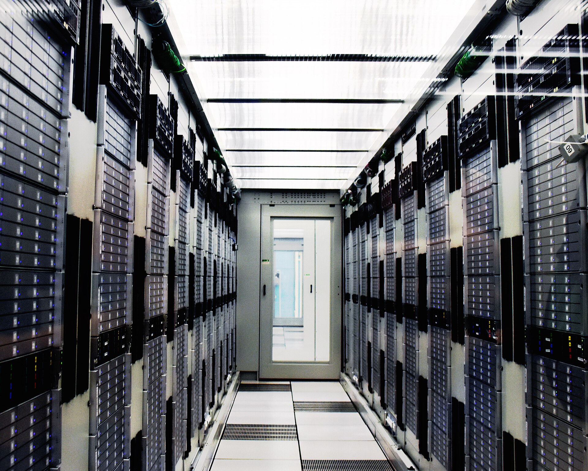 Rows of servers inside a large computer center — the physical infrastructure behind the AI build-out