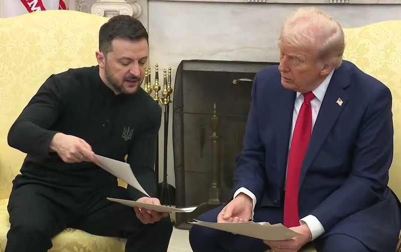 Presidents Volodymyr Zelenskyy and Donald Trump discuss documents in the Oval Office before Ukrainian negotiators visit US