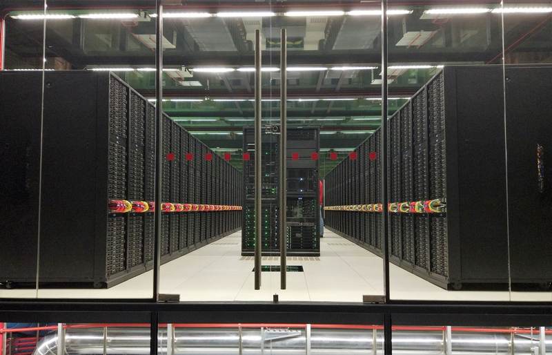 Supercomputer server racks illustrating the infrastructure behind OpenAI agent hacking incidents and AI safety evaluation