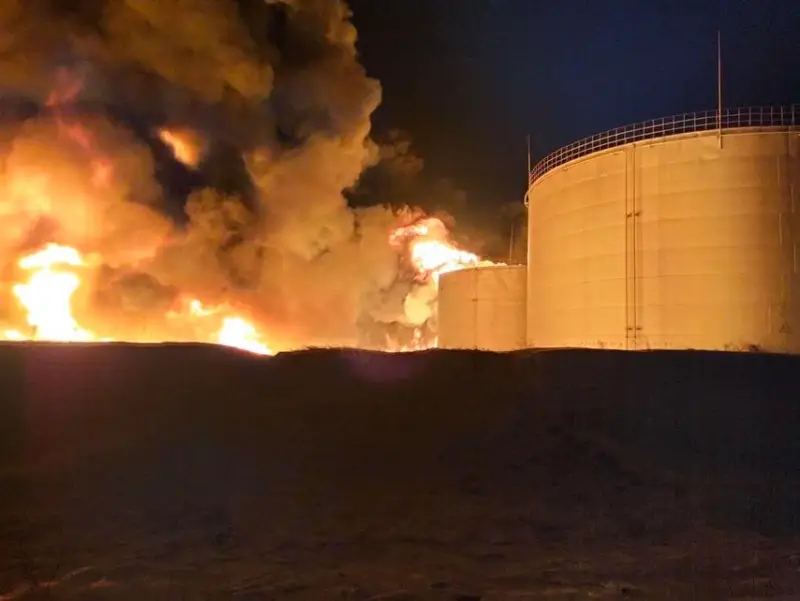 Flames rising near oil storage tanks at night &mdash; Ukraine oil depot strikes September 2026, Krasnodar Krai