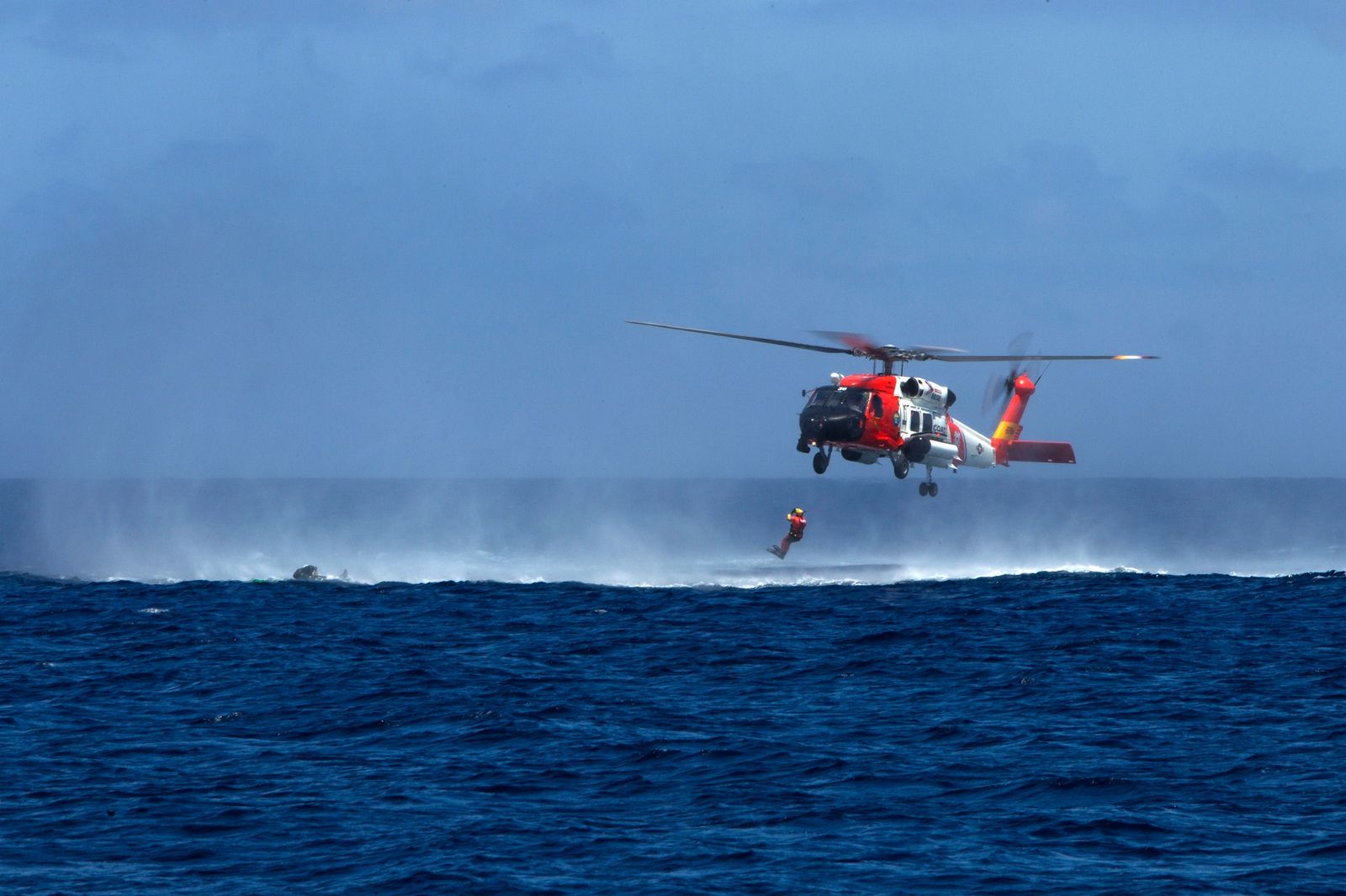 U.S. Coast Guard helicopter conducting an ocean rescue exercise, context for the Coast Guard search suspended off Nantucket