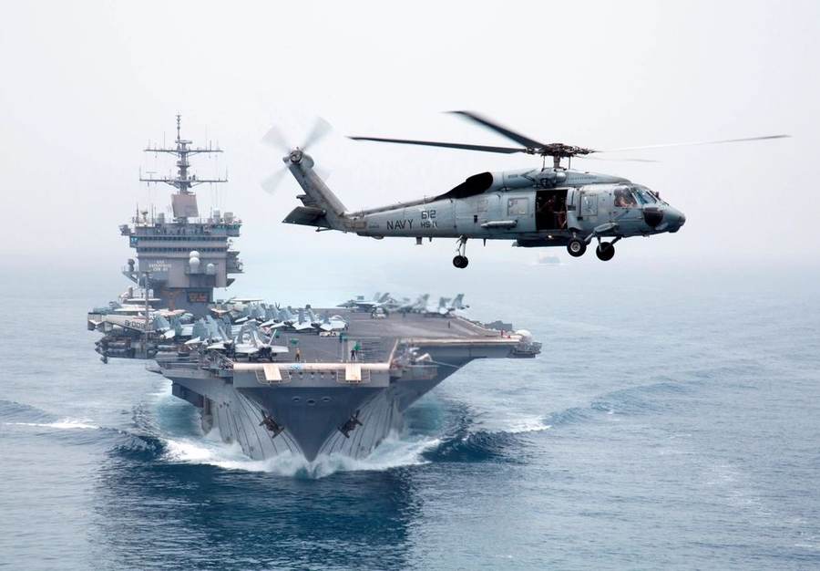 USS Enterprise and Navy helicopter in the Bab el-Mandeb strait, central to the Red Sea shipping crisis