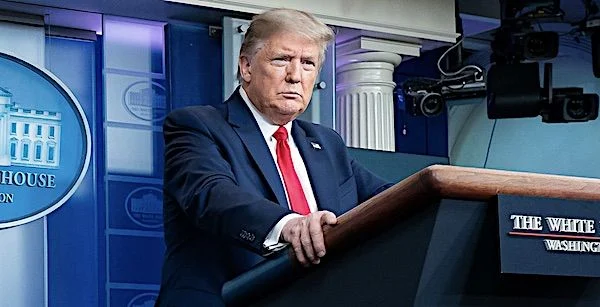 President Donald Trump speaking at a podium during a media address