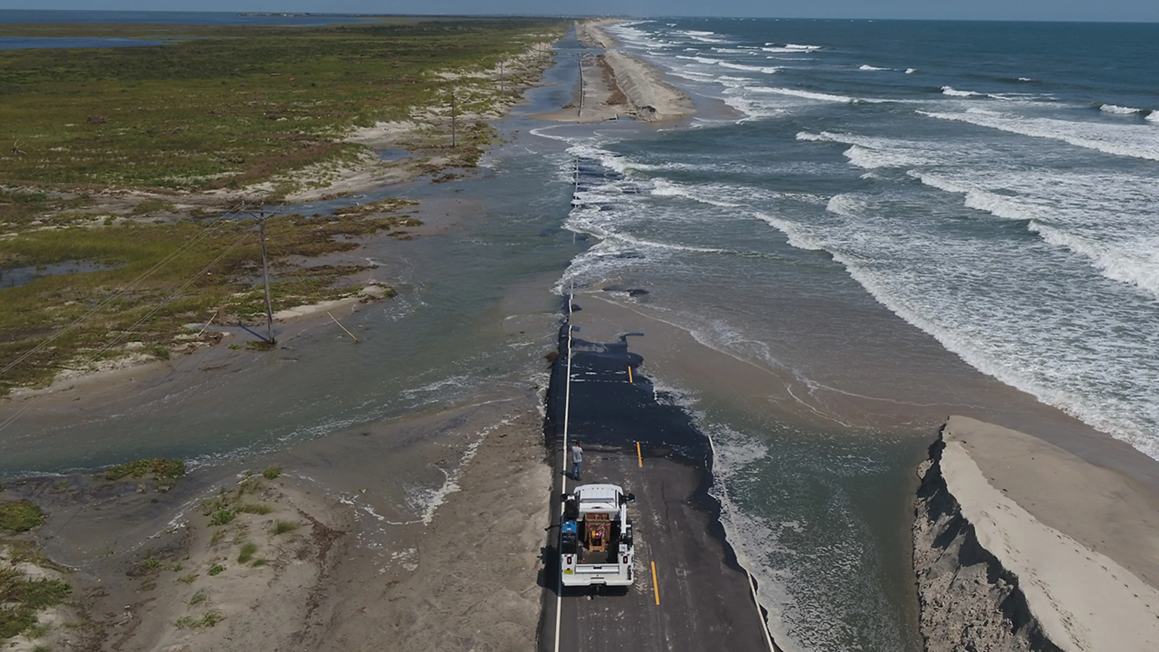 Ocean water washing over NC 12 on North Carolina's Outer Banks during a coastal storm — the October nor'easter threatens 1 to 4 feet of inundation in coastal North Carolina and Virginia, file photo