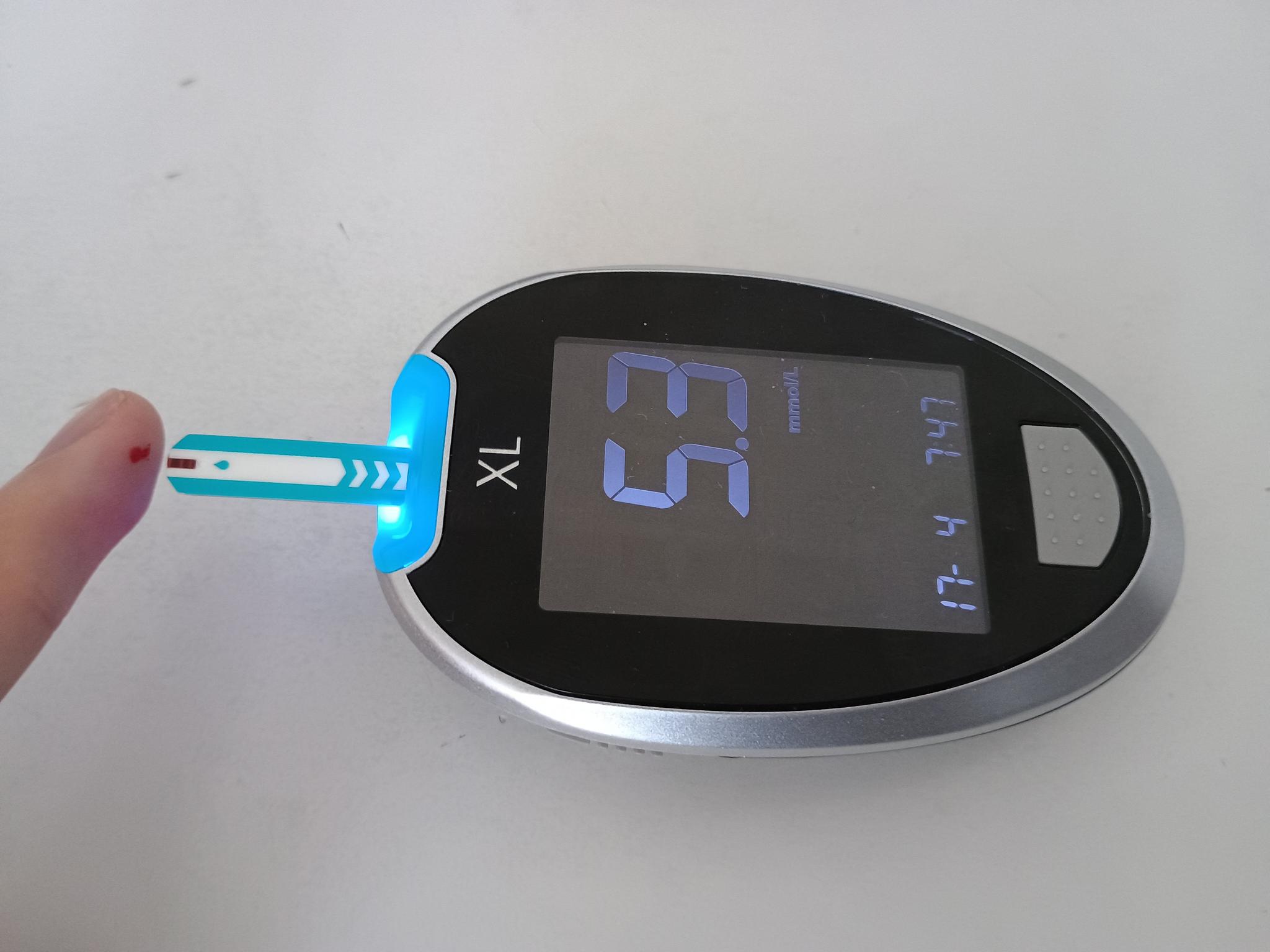 A blood glucose meter in use, with a finger-prick test strip — A1C and blood-sugar control were the primary measures in the retatrutide vs Ozempic TRANSCEND-T2D-2 trial