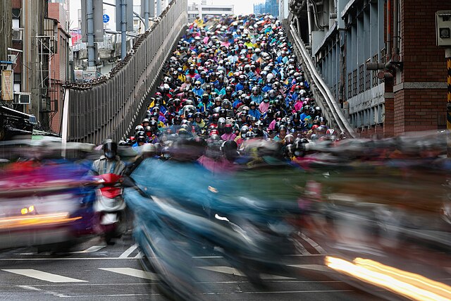 Scooters pour down the Taipei Bridge ramp in the famous Taipei motorcycle waterfall in Taiwan