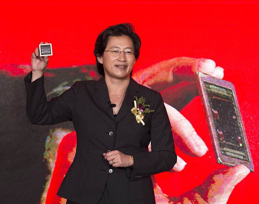 AMD CEO Lisa Su holds a processor during a presentation as she prepares to bring Fei-Fei Li into AMD