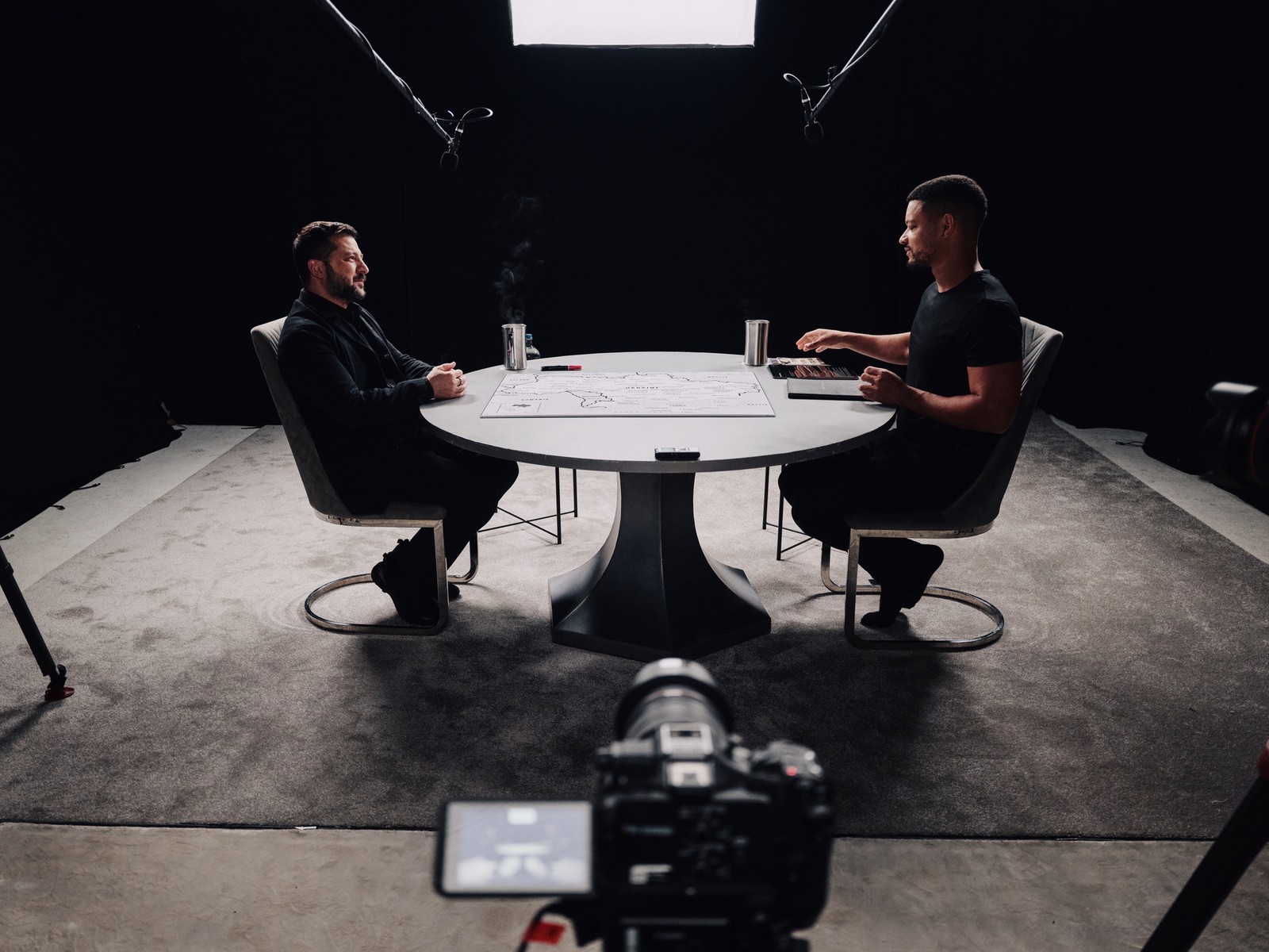 Wide view of The Diary Of A CEO set with Steven Bartlett and President Zelenskyy at the round table during the Zelenskyy interview