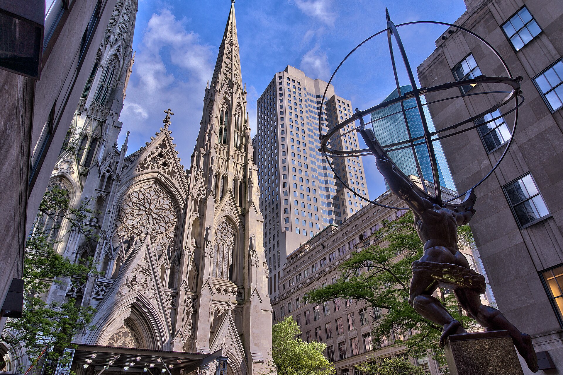 Archdiocese of New York settlement story — St Patrick's Cathedral facade and the Atlas statue in Midtown Manhattan, file photo