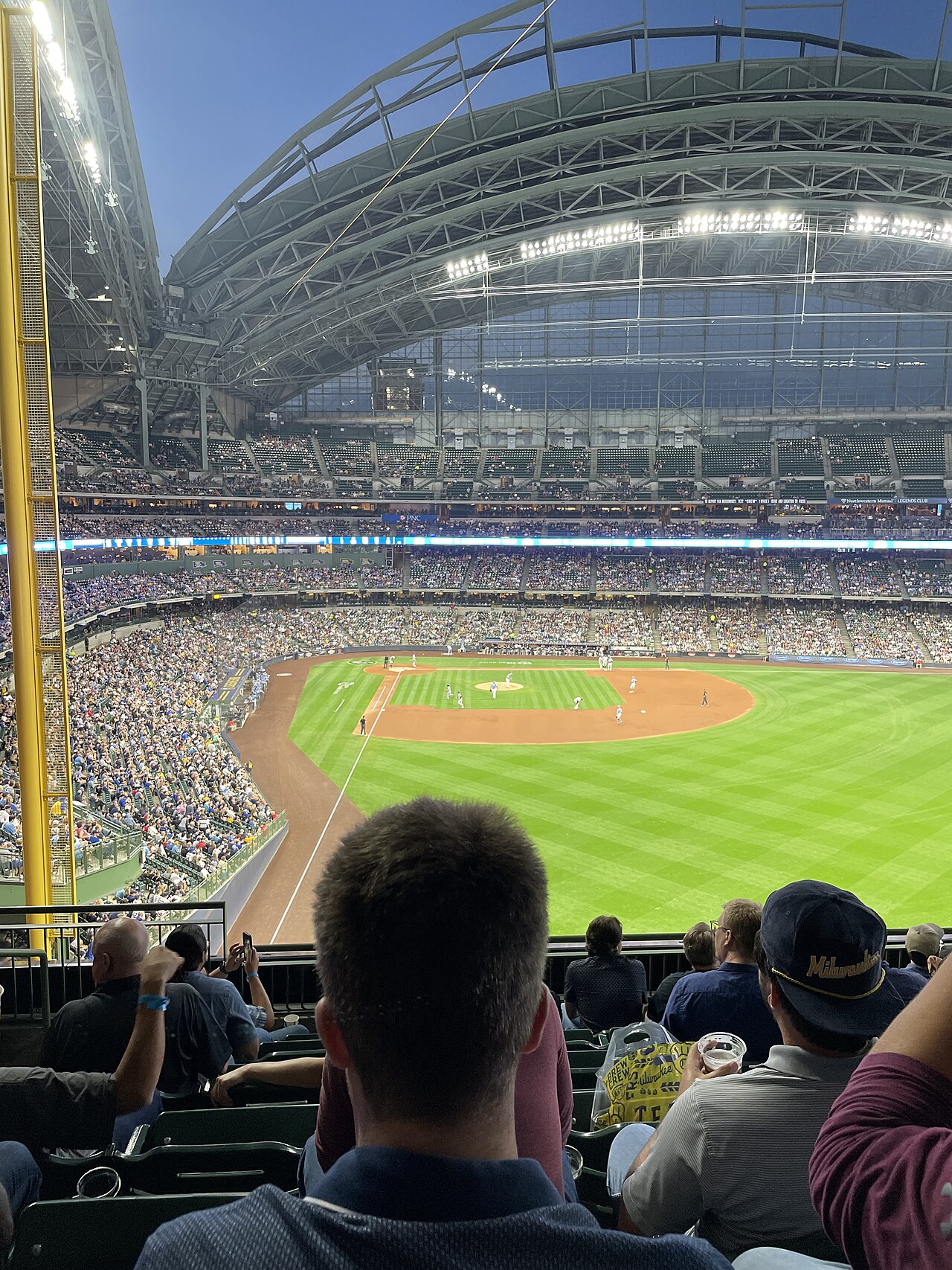 Brewers fans at American Family Field during a game, view from the right field bleachers with the roof open