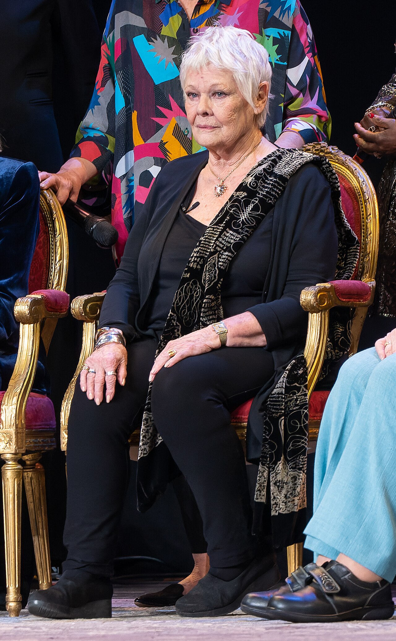 Judi Dench eyesight — Dame Judi Dench seated on stage at the London Palladium in March 2023