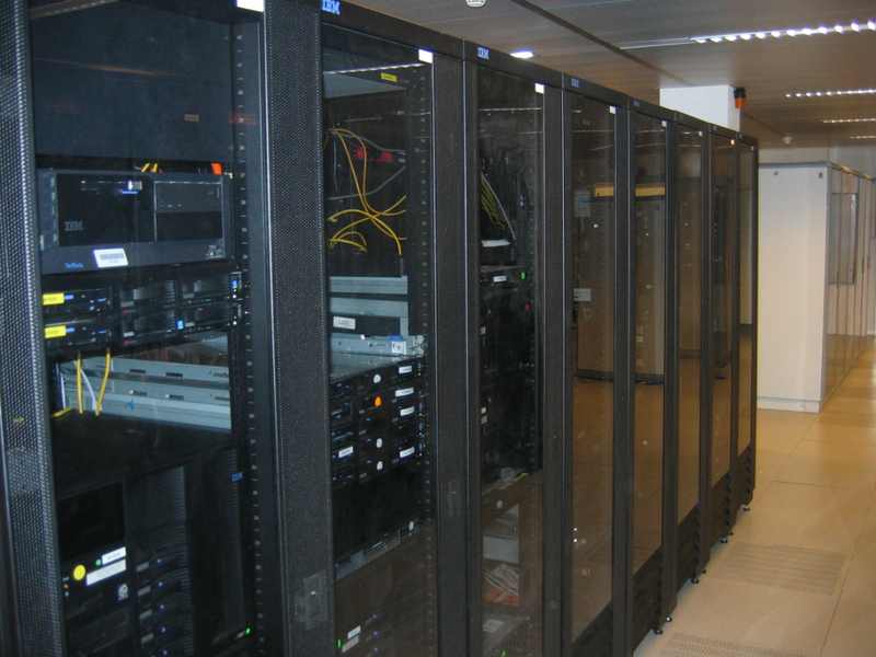 Rows of server racks in a data center — AI data center networking spending could approach $1 trillion through 2030