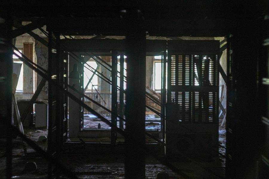 Rows of powered-down empty server racks in a data center — Kiteworks told thousands of customers to shut down their servers over the weekend of September 26, 2026 amid a feared zero-day attack