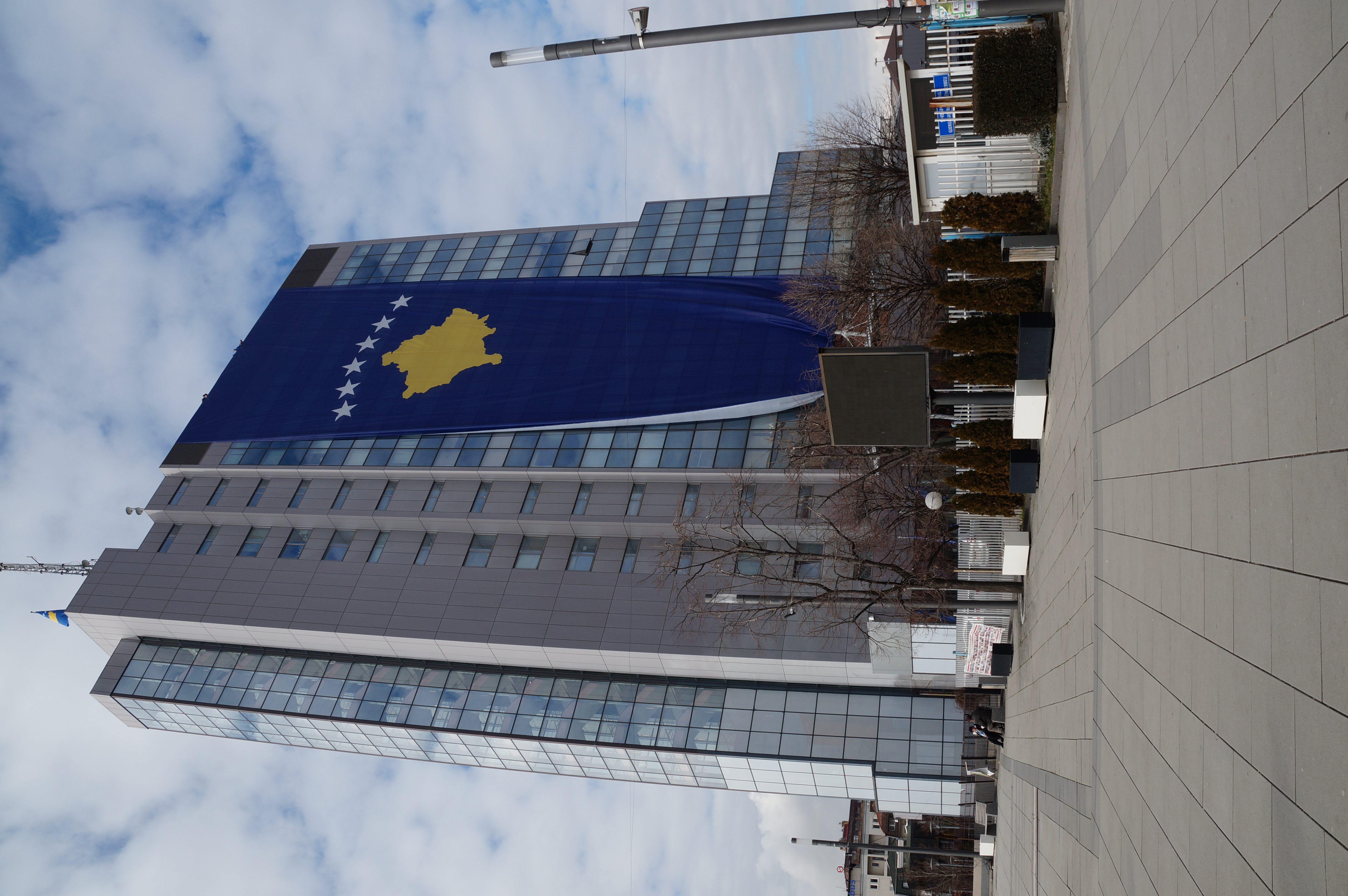 Kosovo flag outside the government building in Pristina near the parliament protest