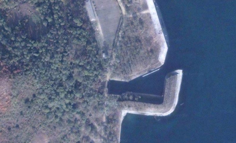 Satellite view of a North Korean submarine pen cut into a rocky coastline — file photo