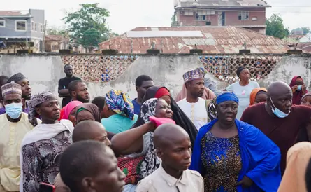 Grieving relatives stand outside General Hospital in Minna after the custody deaths