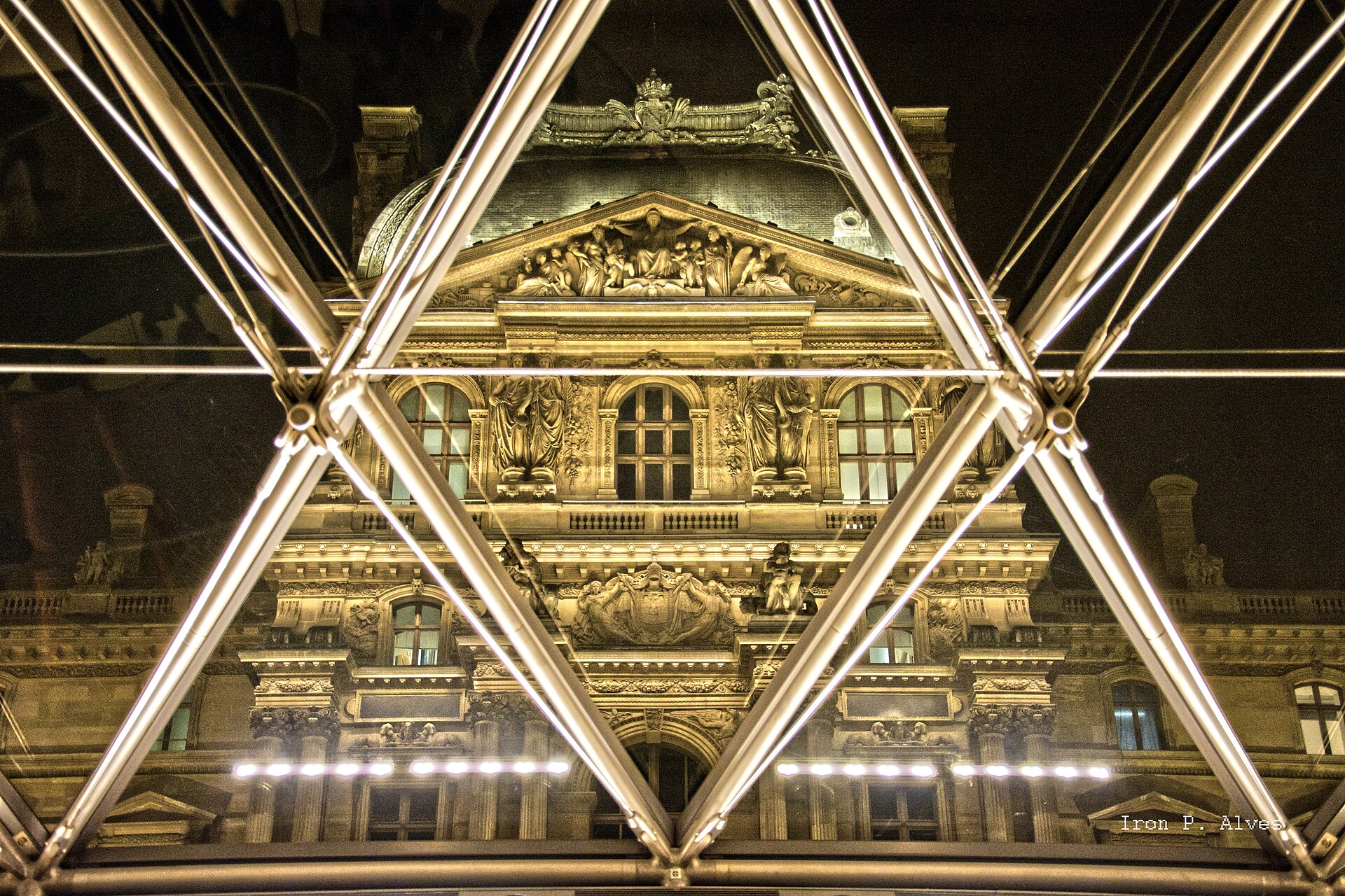 The Louvre in Paris seen through the Pyramid glass at night, where protesters blocked access during the France curfew unrest