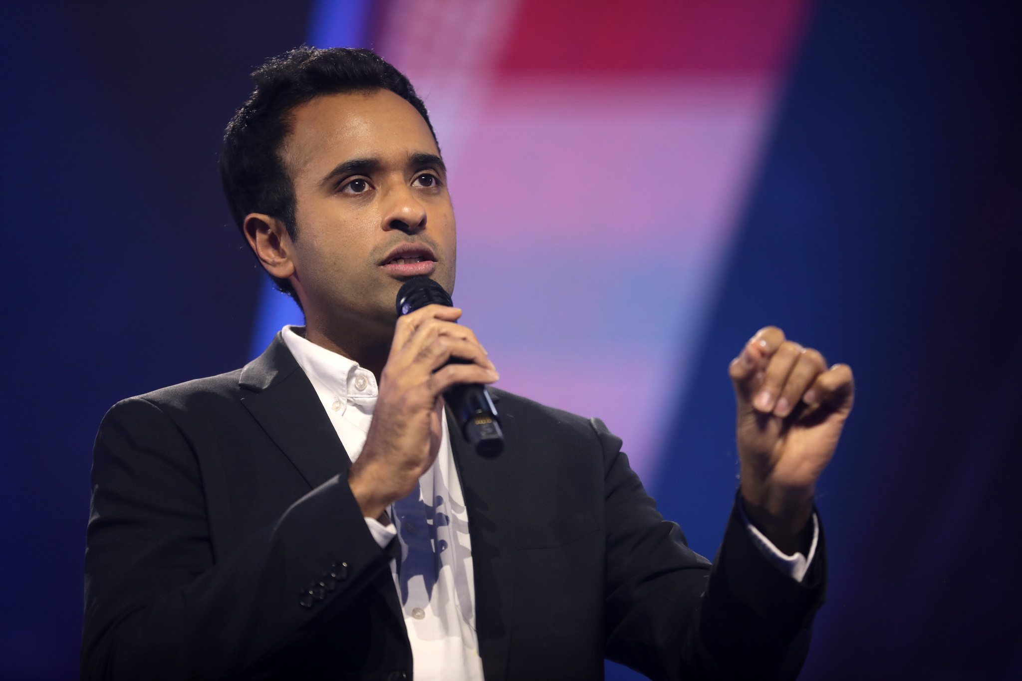Vivek Ramaswamy speaking into a microphone at a campaign event — the Ramaswamy Acton attack ad at the center of the Ohio governor race 2026