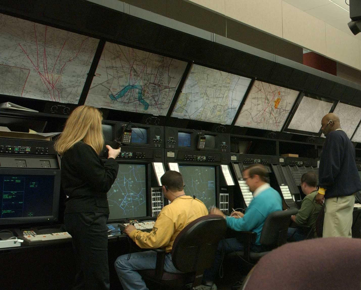 Air route traffic controllers working at radar consoles at Washington Center