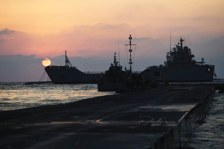 U.S. Army vessels at the Trident Pier off the Gaza coast at sunset — humanitarian access and reconstruction remain central disputes in the stalled ceasefire
