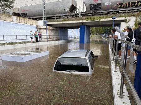 Submerged car beneath an overpass during an earlier Catalonia storm in August 2026