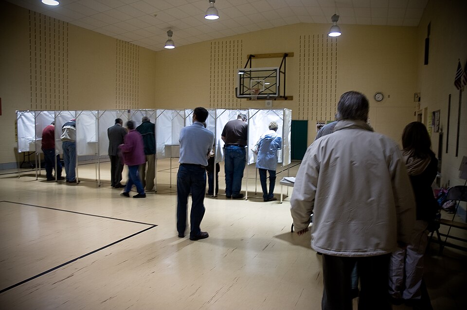 Voting booths in a file photograph representing in-person choices in the November 3 midterm elections 2026