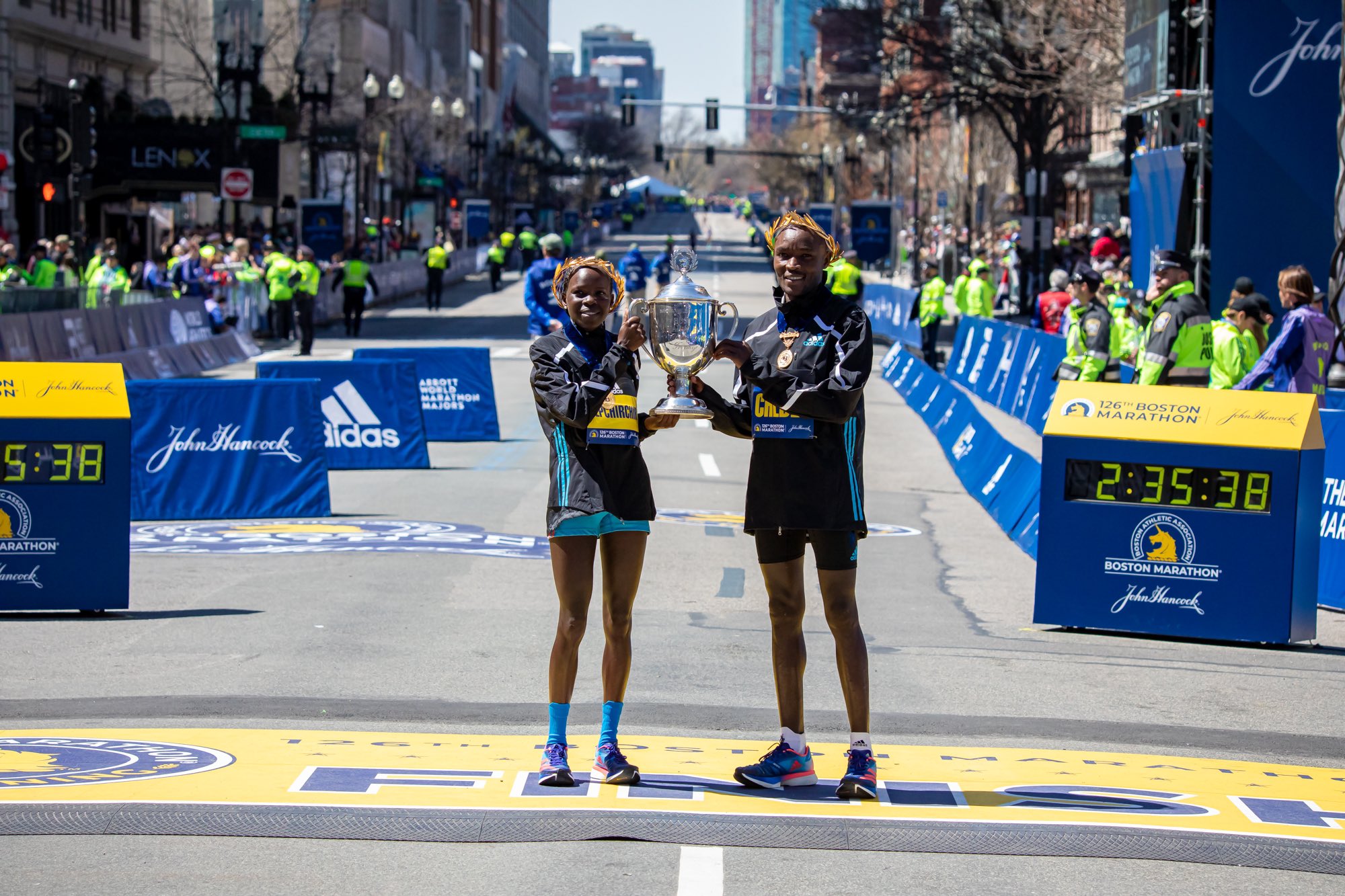 Sydney Marathon winner doping — Jepchirchir holding the Boston Marathon trophy with men's winner Evans Chebet in 2022