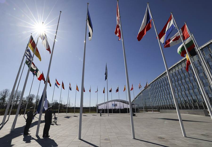 Flags of NATO allies outside headquarters in Brussels during an alliance foreign ministers meeting